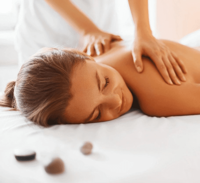 A woman laying on her stomach getting a massage.